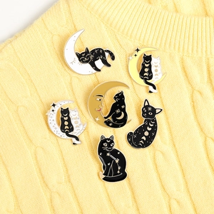 Detailed set of six black and white cat enamel pins with mystical moon and star motifs