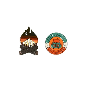 Hiking enamel pins set with bonfire and Pack Lighter Go Further backpack designs