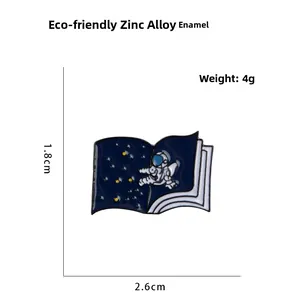 Detail view of astronaut book enamel pin with dimensions and material specifications