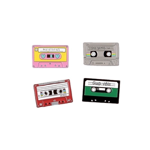 Set of 4 vintage cassette tape enamel pins with retro music themes on white background