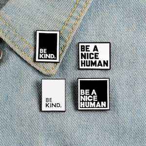 Creative enamel pin set featuring Be Kind and Be A Nice Human slogans on denim jacket