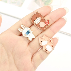 Three cute animal enamel pins featuring a bear, bunny and cat wearing masks