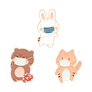 Cute cartoon animal enamel pins featuring a cat, bear, and rabbit wearing masks