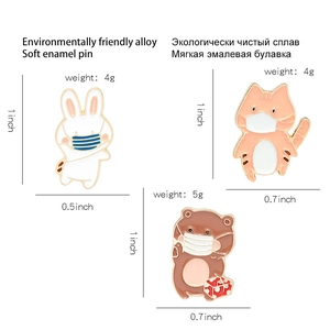 Cute enamel animal pins featuring a bunny, cat with mask, and bear holding a gift bag