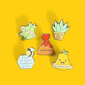 Detailed set of 5 colorful enamel pins with punny slogans like Be-leaf and Pear-fectly