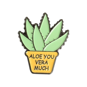 Close-up of aloe vera plant enamel pin with Aloe You Vera Much slogan on pot