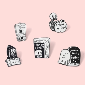 Detailed set of 5 punk gothic enamel pins with skeleton and ghost designs on pink background