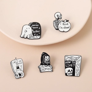 Detail of five-piece punk skull and ghost enamel pins with dark humor text inscriptions