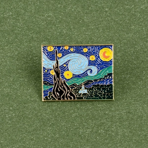 Artistic Vincent Van Gogh Starry Night enamel pin with golden metal edge on green fabric