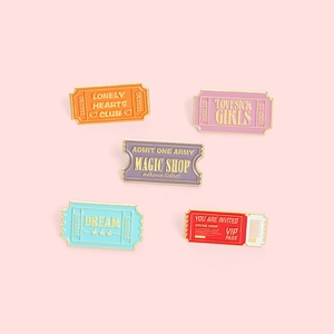 Detailed macro view of vintage ticket enamel pins in colorful zinc alloy finishes