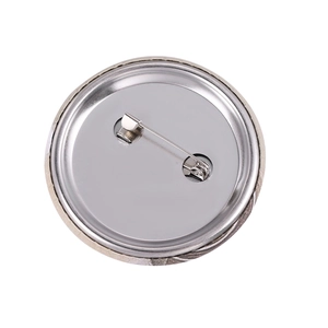 Detailed back view of a round tinplate badge featuring a secure silver metal safety pin