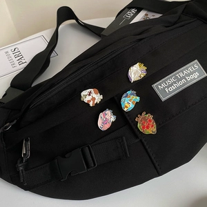 Black canvas chest bag decorated with five colorful anatomical heart enamel pins