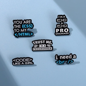 Close-up of programmer enamel pin set with HTML and Ctrl+C elements on blue texture