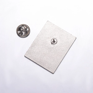 Detail view of the silver alloy rose brooch back with textured finish and butterfly clasp