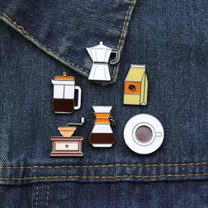 Set of 6 vintage coffee enamel pins including moka pot and grinder on denim jacket