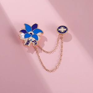 Detailed view of anime style blue flower brooch with gold chains and star emblem badge