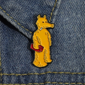 Quasimoto yellow enamel pin on denim jacket representing hip hop street culture style