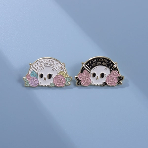 Detail of enamel pins featuring skulls and roses with Til Death We Do Art text