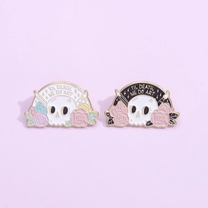 Artistic skull enamel brooch with flowers and Til Death We Do Art text on purple background