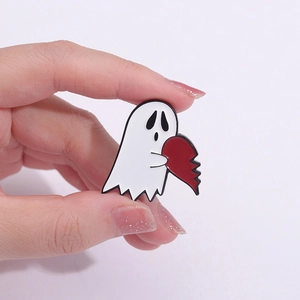 Funny white ghost enamel pin holding a red broken heart, creative Halloween brooch