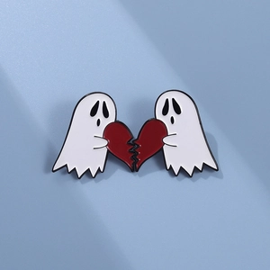Detailed macro of two white enamel ghost pins forming a broken red heart shape