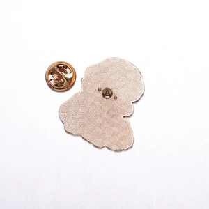 Macro shot of gold metal enamel pin back with honeycomb texture and butterfly clasp