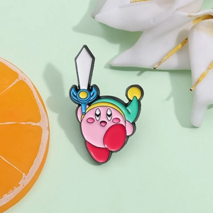 Detailed close-up of pink Kirby enamel pin as Link with sword on green background