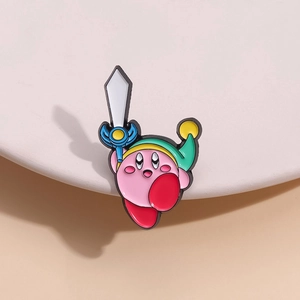 Macro view of a colorful enamel Kirby pin with green hat and sword on a white stage