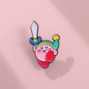 Detailed macro shot of pink enamel Kirby pin featuring a green hero hat and blue sword