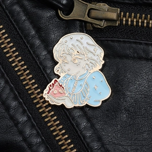 Close-up of enamel pin featuring Sophie and Calcifer pinned on a black leather jacket