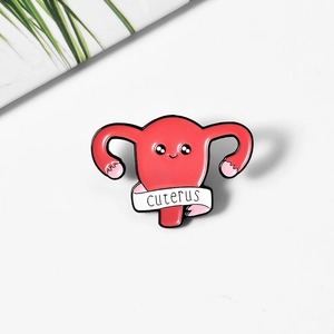 Cute pink cartoon uterus enamel pin with cuterus text and white ribbon detail