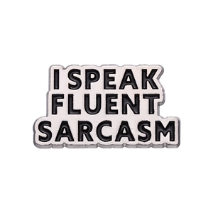 Enamel brooch pin featuring I SPEAK FLUENT SARCASM text on a silver metal base