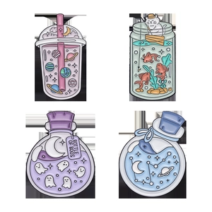 Set of four creative enamel pins featuring cartoon cats, ghosts, and cosmic space themes