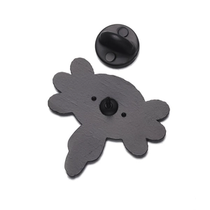 Detail view of the enamel pin back with black rubber clutch and textured metal finish