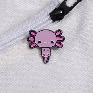 Cute pink axolotl enamel pin attached to a white canvas bag with pink details