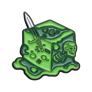 Detail of green slime cube brooch featuring a sword and skeleton inside the enamel