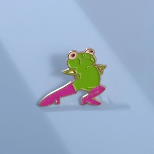 Macro shot of a creative cartoon green frog pin wearing glittery pink high heel boots