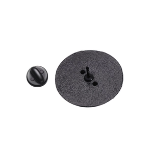 Macro shot of circular pin back showing textured black finish and rubber safety clutch