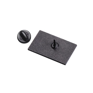 Detailed view of matte black badge clasp components and rectangular brooch pin plate