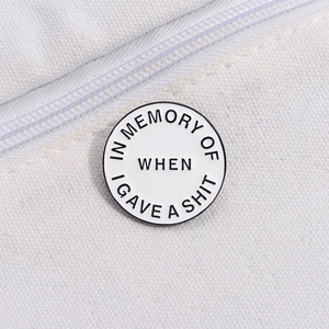 Round enamel pin with humorous text on white canvas background for fashion