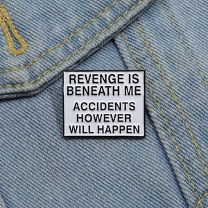 Detailed macro of enamel metal pin with humorous quote on blue denim jacket texture