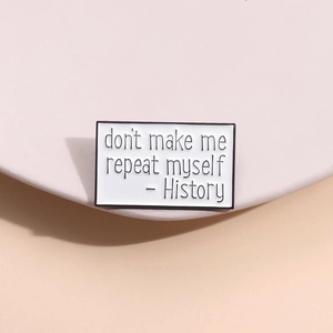 History don't make me repeat myself enamel pin with black letters on white background