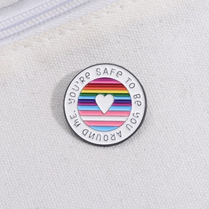 Rainbow striped round metal badge with heart and text pinned on white canvas bag