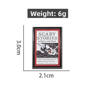 Detail shot of Scary Stories book enamel pin showing 3.0cm height and 2.1cm width dimensions