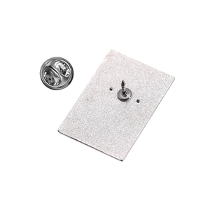 Detail view of the silver metal pin back with a butterfly clutch on a white background