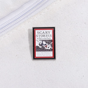 Scary Stories to Tell in the Dark enamel pin with iconic horror book cover illustration