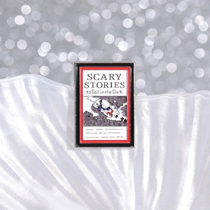 Macro shot of Scary Stories to Tell in the Dark enamel pin with skull illustration