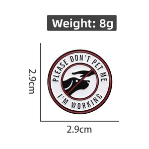 Detail view of round metal enamel pin with DO NOT PET working dog sign, 2.9cm diameter