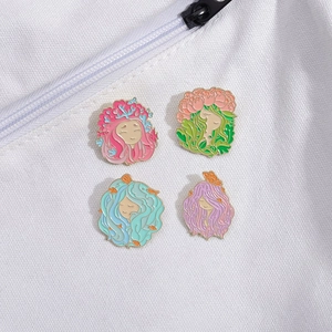 Set of four artistic enamel pins featuring dreaming girls with natural floral elements