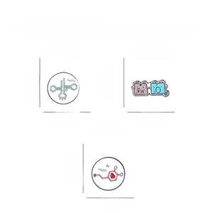 Detail view of medical enamel pins with Be Lucky and Be Happy text on white background